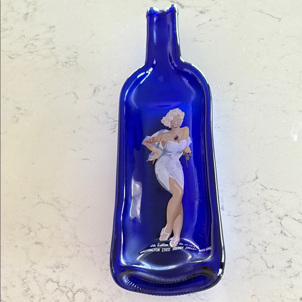 Vibrant Blue Bottle with Iconic Figure Design